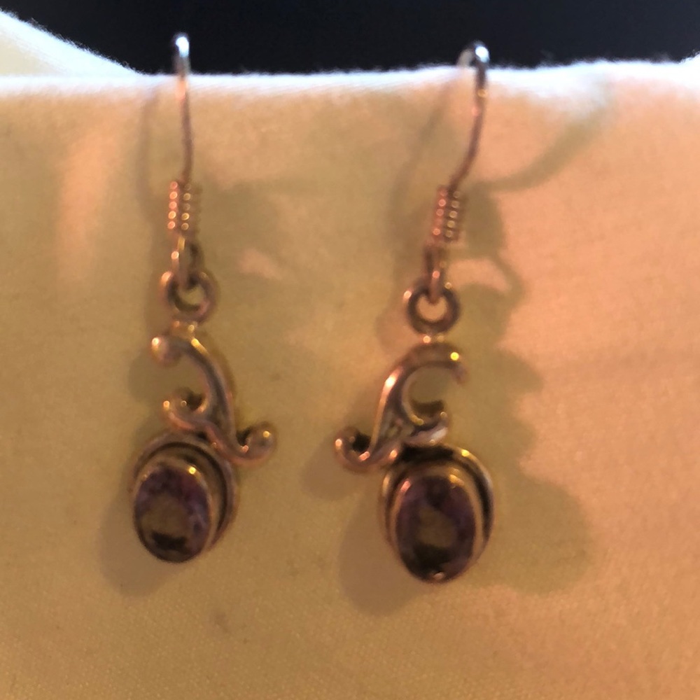 Purple stones set in pure silver earrings
